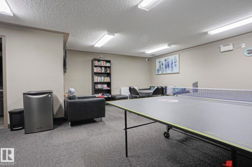 Recreation room featuring a ping pong table, carpeted flooring, and recessed lighting - 201 1520 Hammond Gate Gate, Edmonton, AB - Indoor