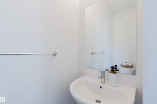 Contemporary wall-mounted sink with polished chrome faucet - 5237 Edgemont Boulevard, Edmonton, AB - Indoor Photo Showing Bathroom