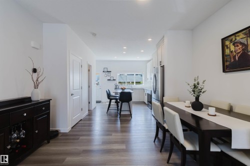 Open-concept living space featuring wood-finish flooring, recessed lighting, and white walls - 5237 Edgemont Boulevard, Edmonton, AB - Indoor Photo Showing Dining Room