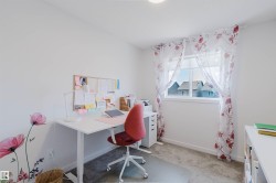 Carpeted room featuring a white-framed window, white walls, and a recessed ceiling light - 