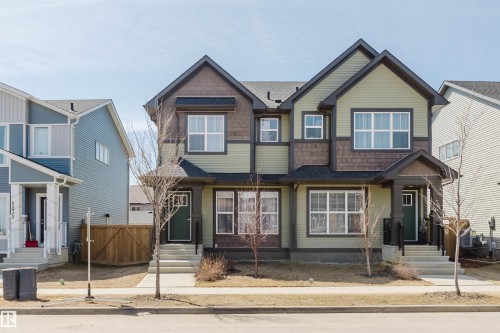 Modern two-story duplex with a blend of horizontal siding and shake accents - 5237 Edgemont Boulevard, Edmonton, AB - Outdoor With Facade