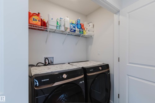 Dedicated laundry area featuring a wire storage shelf, a water hookup, and a 2-panel interior door - 5237 Edgemont Boulevard, Edmonton, AB - Indoor Photo Showing Laundry Room
