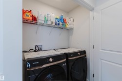 Dedicated laundry area featuring a wire storage shelf, a water hookup, and a 2-panel interior door - 