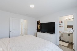 Bedroom featuring a recessed ceiling light, white walls, and carpet flooring - 