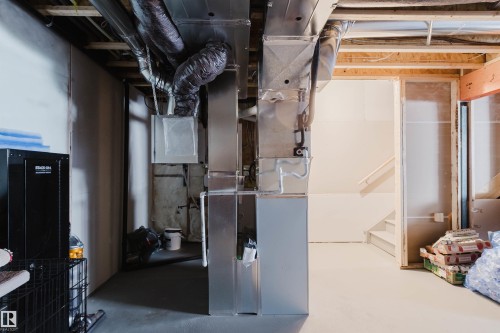 Unfinished basement space featuring exposed joists and framing, with visible HVAC ductwork and utility lines - 5237 Edgemont Boulevard, Edmonton, AB - Indoor Photo Showing Basement