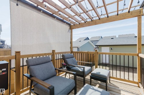 Expansive wood-finish deck featuring a slatted pergola with string lighting - 5237 Edgemont Boulevard, Edmonton, AB - Outdoor With Deck Patio Veranda With Exterior