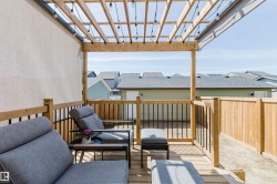 Outdoor deck with wooden pergola and string lighting - 