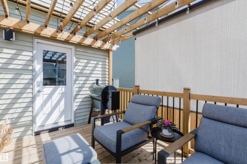 Outdoor deck featuring wood-finish flooring, a slatted pergola overhead, and a privacy screen - 5237 Edgemont Boulevard, Edmonton, AB - Outdoor With Deck Patio Veranda With Exterior
