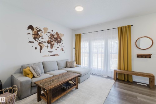Bright living space featuring recessed lighting, large windows with full-length drapery, and wood-finish flooring - 5237 Edgemont Boulevard, Edmonton, AB - Indoor Photo Showing Living Room