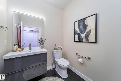 Modern floating vanity with an integrated rectangular sink and polished chrome faucet - 8967 24 Avenue, Edmonton, AB - Indoor Photo Showing Bathroom