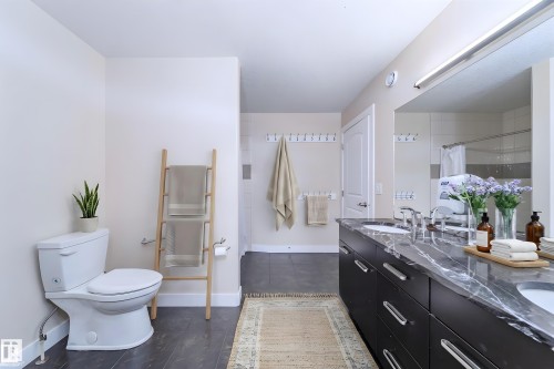 Dual vanity with undermount sinks and a dark marble-patterned countertop - 8967 24 Avenue, Edmonton, AB - Indoor Photo Showing Bathroom