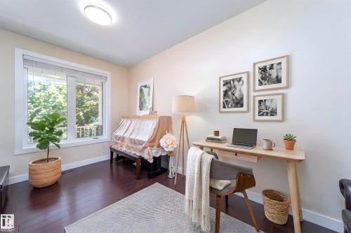 Brightly lit room featuring rich wood-finish flooring - 8967 24 Avenue, Edmonton, AB - Indoor Photo Showing Office