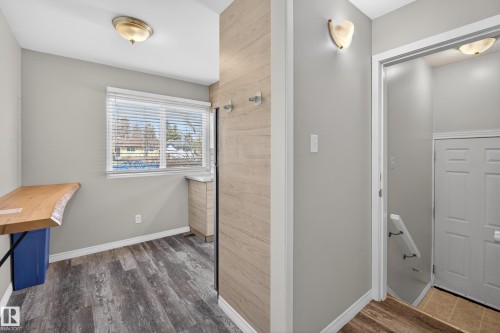 Versatile entryway featuring wood-finish flooring, light gray wall paint, and a built-in live-edge wood shelf - 5 Linden St, Spruce Grove, AB - Indoor Photo Showing Other Room