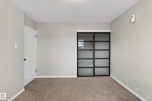 Wall-to-wall carpeted room with light gray painted walls - 5 Linden St, Spruce Grove, AB - Indoor Photo Showing Other Room