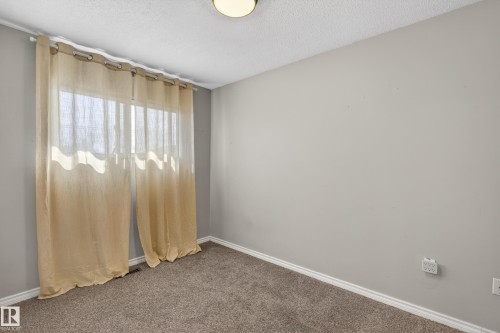 Neutral wall finishes complement the textured carpeting - 5 Linden St, Spruce Grove, AB - Indoor Photo Showing Other Room