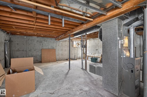 Unfinished basement featuring concrete walls and flooring, exposed wooden ceiling joists, and a visible HVAC system - 5 Linden St, Spruce Grove, AB - Indoor Photo Showing Basement