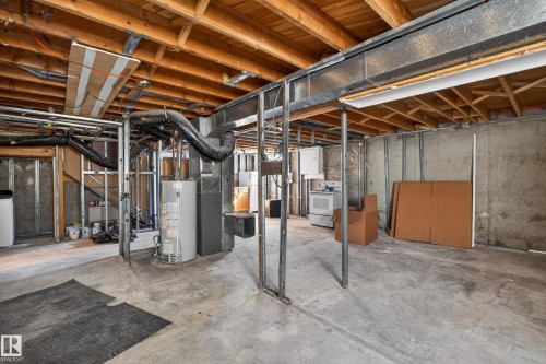 Unfinished basement featuring exposed wood joists and concrete flooring - 5 Linden St, Spruce Grove, AB - Indoor Photo Showing Basement