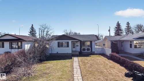 Single-story home featuring light-colored siding, a dark shingle roof, and a front yard with a stone pathway - 5 Linden St, Spruce Grove, AB - Outdoor With Facade