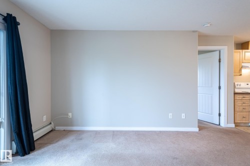 Carpeted interior space with neutral wall tones and white baseboards - #314 240 Spruce Ridge Rd, Spruce Grove, AB - Indoor Photo Showing Other Room