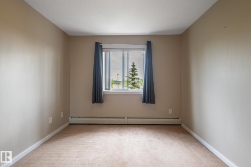 Neutral-toned walls, plush carpet, and white trim create a versatile space - #314 240 Spruce Ridge Rd, Spruce Grove, AB - Indoor Photo Showing Other Room