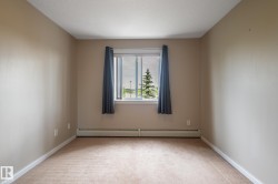 Neutral-toned walls, plush carpet, and white trim create a versatile space - 