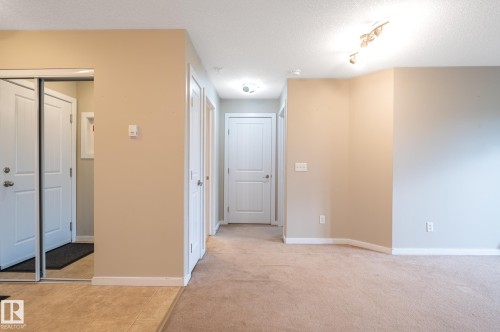 Entryway featuring tile flooring, mirrored closet doors, and neutral wall tones - #314 240 Spruce Ridge Rd, Spruce Grove, AB - Indoor Photo Showing Other Room