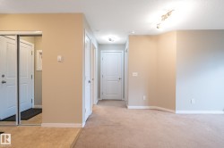 Entryway featuring tile flooring, mirrored closet doors, and neutral wall tones - 