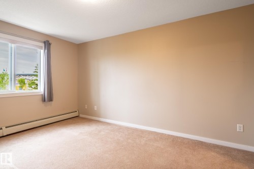 Neutral-toned walls complement plush carpeting - #314 240 Spruce Ridge Rd, Spruce Grove, AB - Indoor Photo Showing Other Room