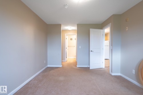 Interior space featuring neutral wall paint, carpet flooring, white trim, and white interior doors - #314 240 Spruce Ridge Rd, Spruce Grove, AB - Indoor Photo Showing Other Room