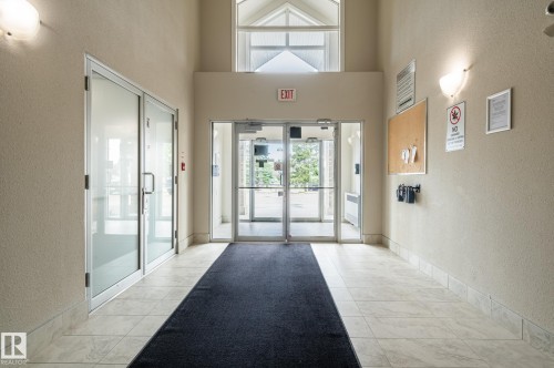 Spacious entryway featuring a vaulted ceiling and a large transom window - #314 240 Spruce Ridge Rd, Spruce Grove, AB - Indoor Photo Showing Other Room