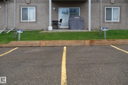 Paved parking area featuring clear yellow stripe markings - 