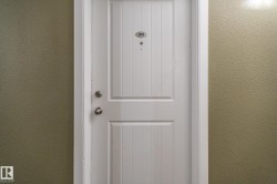 White paneled entry door with brushed nickel hardware - 