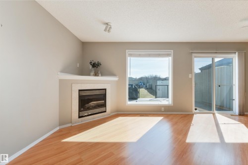 2923 30 Street, Edmonton, AB - Indoor Photo Showing Living Room With Fireplace
