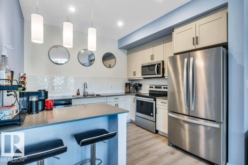 105 1304 Rutherford Rd Road, Edmonton, AB - Indoor Photo Showing Kitchen With Stainless Steel Kitchen With Upgraded Kitchen