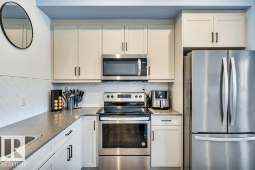 105 1304 Rutherford Rd Road, Edmonton, AB - Indoor Photo Showing Kitchen With Stainless Steel Kitchen
