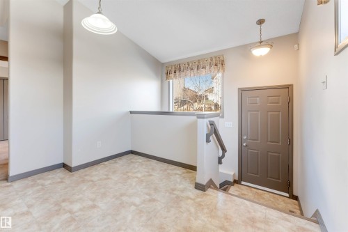 Entryway featuring a paneled door, light-toned walls, and patterned flooring - 4812 148 Avenue, Edmonton, AB - Indoor Photo Showing Other Room