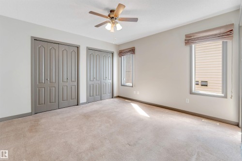 Neutral-toned carpeting paired with light-colored walls - 4812 148 Avenue, Edmonton, AB - Indoor Photo Showing Other Room