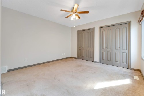 Spacious room featuring neutral carpeting and light-toned walls - 4812 148 Avenue, Edmonton, AB - Indoor Photo Showing Other Room