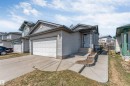 Siding exterior with an attached single-car garage and concrete driveway - 4812 148 Avenue, Edmonton, AB  - Outdoor 