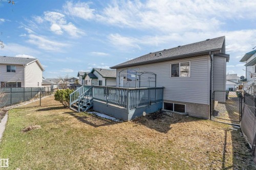 Rear exterior featuring a spacious wooden deck with railings and steps - 4812 148 Avenue, Edmonton, AB - Outdoor With Deck Patio Veranda With Exterior