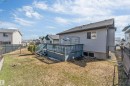 Rear exterior featuring a spacious wooden deck with railings and steps - 4812 148 Avenue, Edmonton, AB  - Outdoor With Deck Patio Veranda With Exterior 