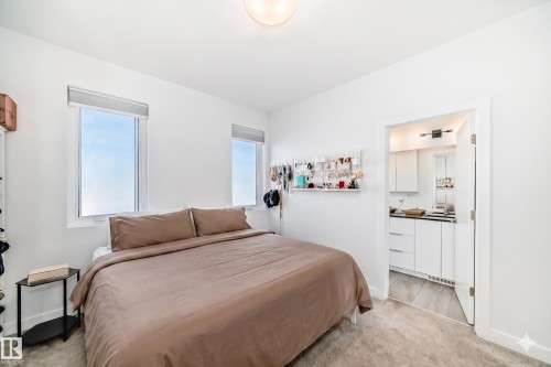 Bedroom with bright white walls, two windows, and light gray carpeting - 14812 98 Avenue, Edmonton, AB - Indoor Photo Showing Bedroom
