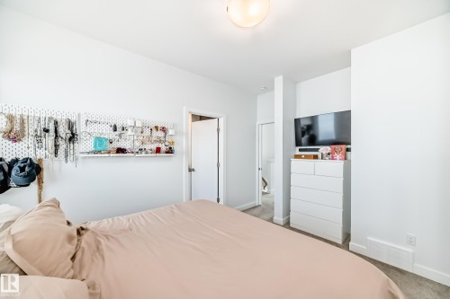 Bright room with neutral wall paint, light gray carpeting, and a flush-mount ceiling light fixture - 14812 98 Avenue, Edmonton, AB - Indoor Photo Showing Bedroom