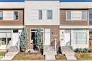 Modern townhome exterior featuring a clean-lined facade with white stucco and horizontal wood-finish siding - 14812 98 Avenue, Edmonton, AB  - Outdoor With Facade 
