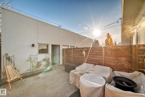 Private concrete patio bordered by a horizontal wood fence - 14812 98 Avenue, Edmonton, AB - Outdoor With Exterior