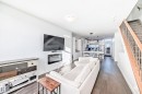 Open concept living space featuring wood-finish flooring and a built-in electric fireplace - 14812 98 Avenue, Edmonton, AB  - Indoor Photo Showing Living Room 