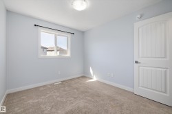 Neutral-toned carpet flooring complementing light blue walls - 