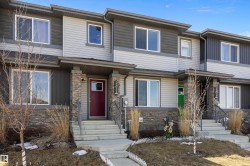 Multi-level townhome featuring a stone and siding exterior - 