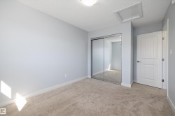 Neutral-toned carpet flooring complementing light blue wall paint - 