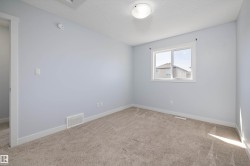 Neutral-toned wall paint and plush carpeting create a versatile interior space - 